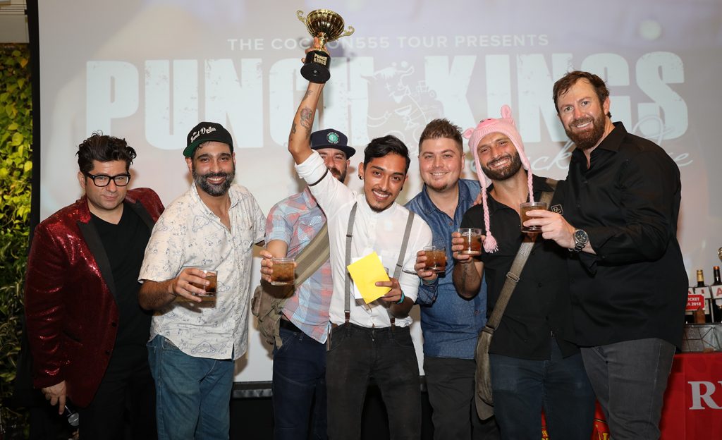 group of people with punch kings trophy