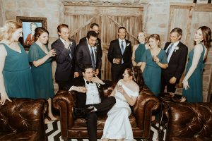 wedding party, bride, and groom drinking cocktails