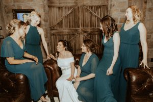 bride and bridesmaids sitting on couch