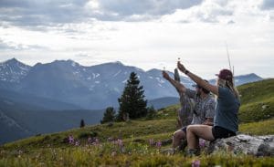 two people drinking whiskey shooters outside in the mountains