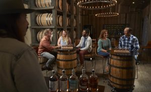 Friends tasting whiskey flights in tasting room